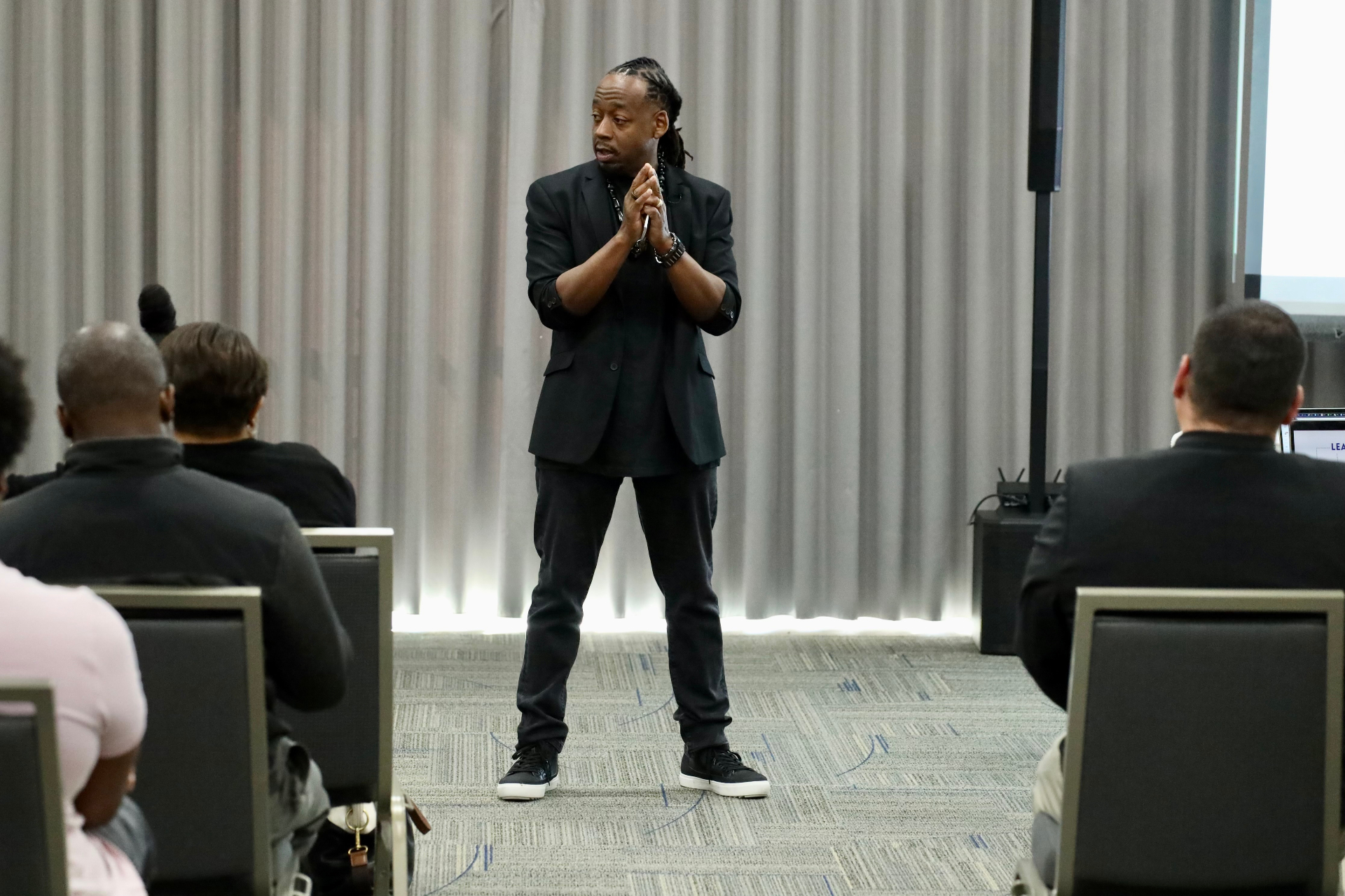 Tommy speaking on a large conference stage